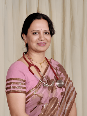 Dr. B. Padmaja, Founder and Chief Fertility Specialist, in a sari with a stethoscope
